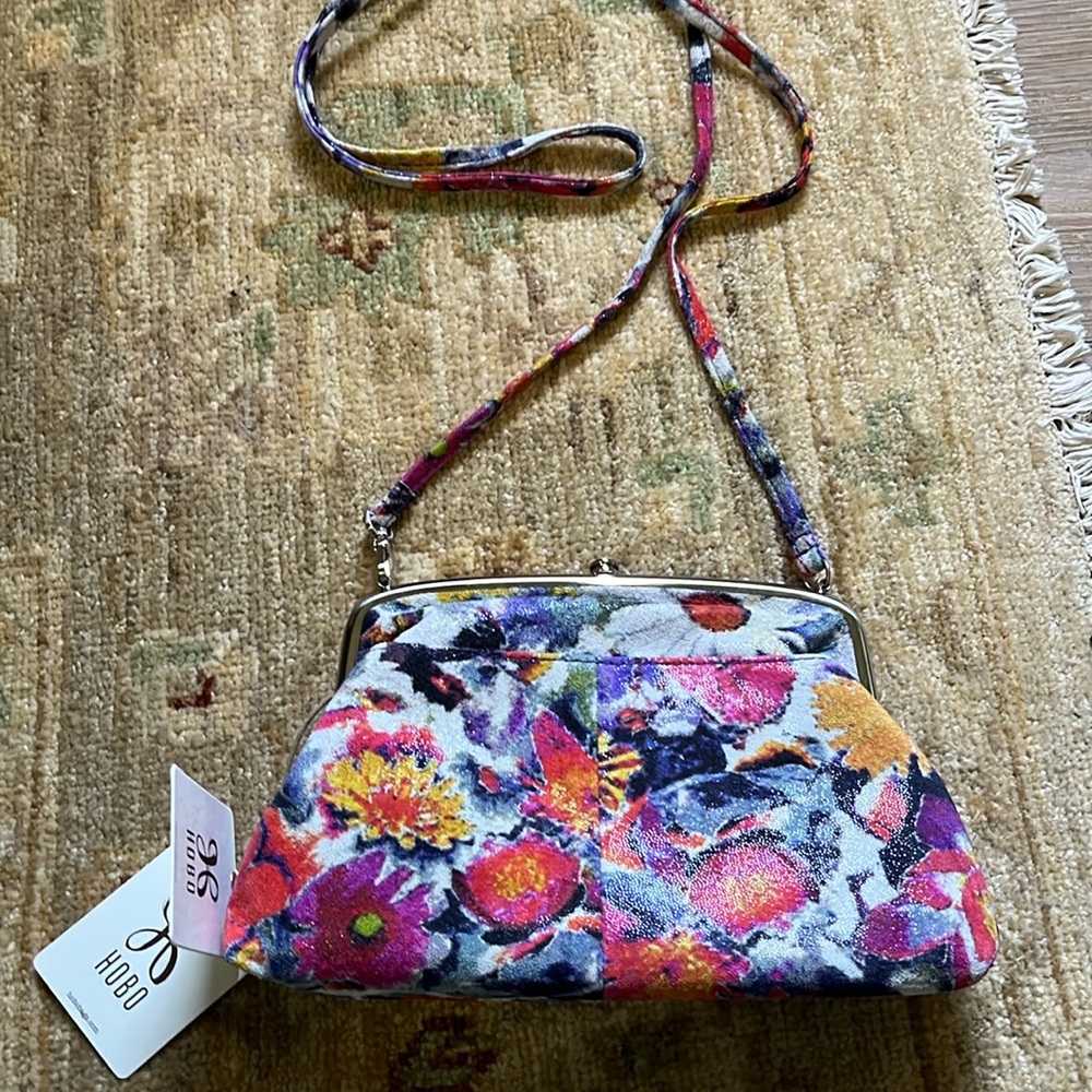 Hobo floral crossbody. NWT. Inside pockets and an outside pocket. Long strap.